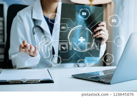 Medicine doctor using digital tablet and smartphone diagnose virtual electronic medical record on interface.Digital healthcare and network on virtual screen 128645876