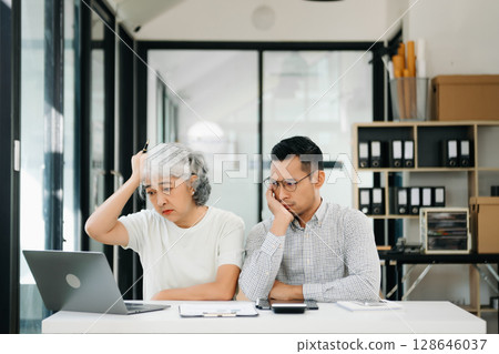 Furious two Asian businesspeople arguing strongly after making a mistake at work 128646037