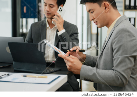 Business team meeting,work process.professional crew working with new startup project.Project managers. business plans, Laptop smartphone hands. Business team meeting,work process.professional crew working with new startup project.Project managers. business plans, Laptop smartphone hands. 128646424