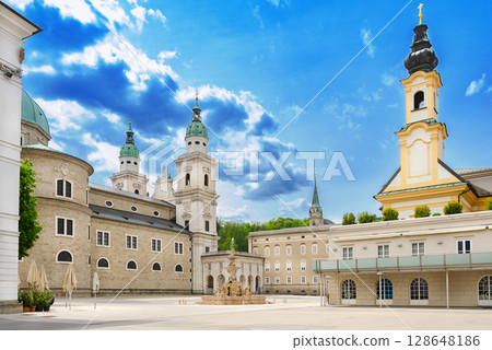 Salzburg Residenzplatz with Cathedral, Old Residence, and St. Michaels Church. Large square in the historic center of Salzburg in Austria, and with the Baroque fountain Residenzbrunnen in the center. Salzburg Residenzplatz with Cathedral, Old Residence, and St. Michaels Church. Large square in the historic center of Salzburg in Austria, and with the Baroque fountain Residenzbrunnen in the center. 128648186