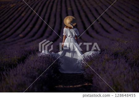 Lavender woman field Provence summer. Back view of girl in white dress in Provence lavender field. 128648455