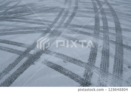 Tire tracks on a snowy day Tire tracks on a snowy day 128648804