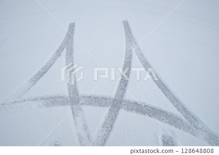Tire tracks on a snowy day Tire tracks on a snowy day 128648808