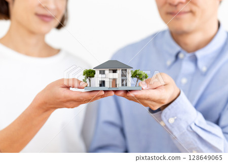 A middle-aged couple choosing a home A middle-aged couple choosing a home 128649065