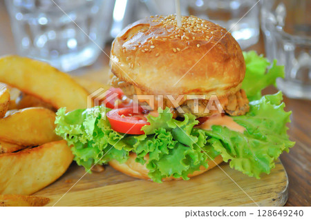 chicken burger or hamburger and french fries or chips 128649240