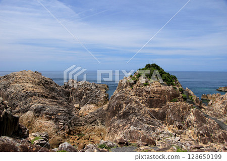 The cliffs of the cliffs of the cliffs and the horizon seen in the distance 128650199