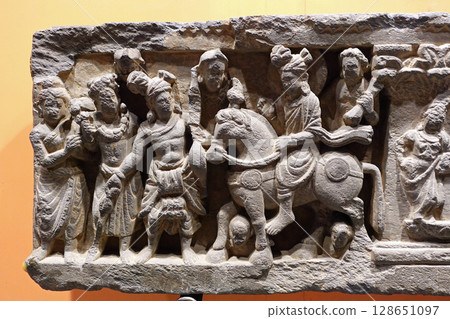 A small sculpture on display at the Peshawar Museum in Pakistan, which displays detailed biographical sculptures depicting the life of the Buddha. 128651097