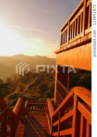 Observation deck, stairs, sunset sky, sunset, mountains, forest Observation deck, stairs, sunset sky, sunset, mountains, forest 128652972