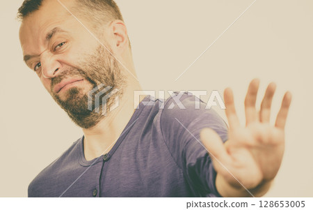 Man showing stop gesture Man showing stop gesture 128653005