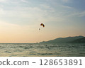 Stunning aerial landscape of Thailand with a colorful parachute gliding over lush tropical scenery, mountains, and turquoise sea. Adventure and travel concept, perfect for tourism, outdoor sports, and 128653891