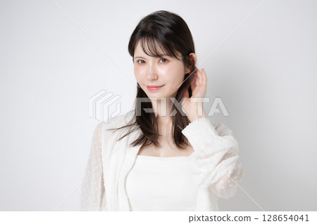 A woman touching her hair A woman touching her hair 128654041