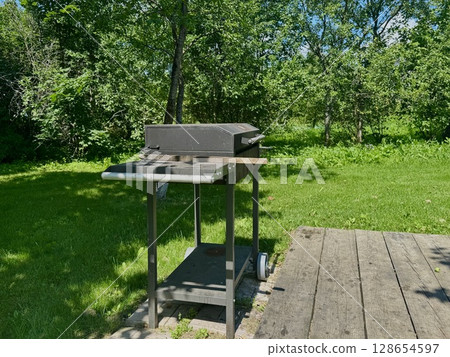 barbecue area on the territory of a country house on a summer day. High quality photo 128654597