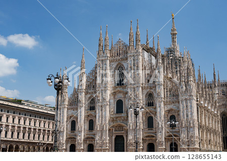 Milan Cathedral (Duomo di Milano). Gothic architecture against the blue sky, Italy. Milan Cathedral (Duomo di Milano). Gothic architecture against the blue sky, Italy. 128655143