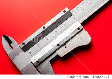 Close-up of a caliper on a bright saturated background. A tool for precise and accurate measurement Close-up of a caliper on a bright saturated background. A tool for precise and accurate measurement 128655271