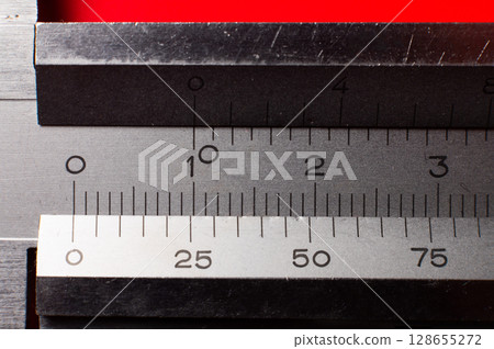 Macro shot of numbers on a caliper. The concept of precise and accurate measurement, professionalism and competence 128655272