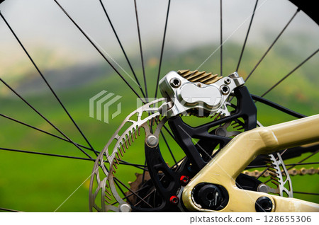 Close-up of a mountain bike brake system. Close-up of the rear wheel. Brake disc and caliper of a mountain bike hydraulic brake system 128655306