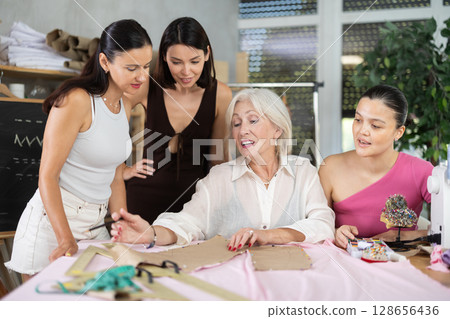 Mature female teacher showing how to draw dress detail 128656436