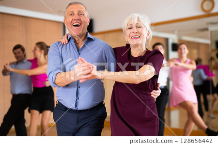 Elderly pair practicing Latino dance in dance studio 128656442