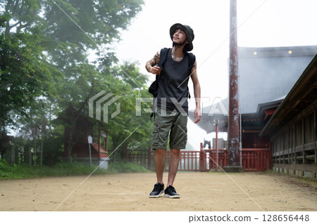 An inbound man walking through a foggy shrine An inbound man walking through a foggy shrine 128656448