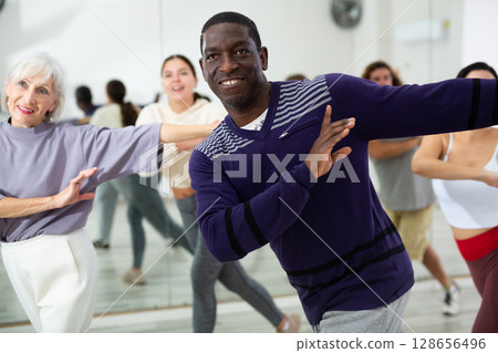 Positive African American man practicing vigorous dance 128656496