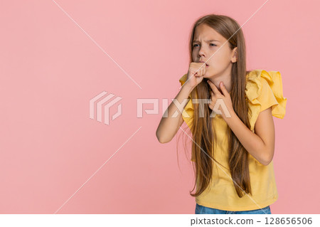 Little child girl kid touching sore throat coughing and showing discomfort with sad expression Little child girl kid touching sore throat coughing and showing discomfort with sad expression 128656506