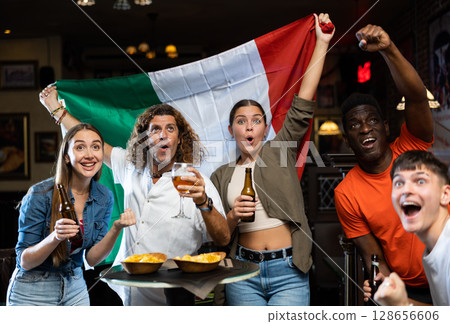 Joyful fans of the Italian team celebrating the victory in night bar Joyful fans of the Italian team celebrating the victory in night bar 128656606