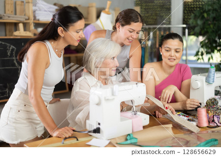Mature woman showing how to sew 128656629