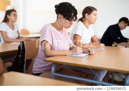Woman attending lecture in college 128656635