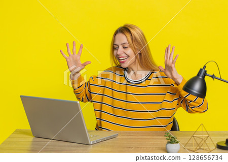 Happy woman working on laptop shocked by victory celebrate winning goal achievement good career news 128656734