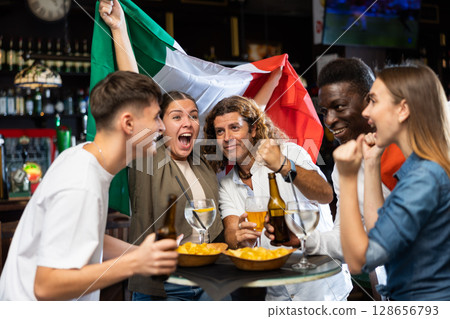 Group of Italy football team fans spending time in bar 128656793