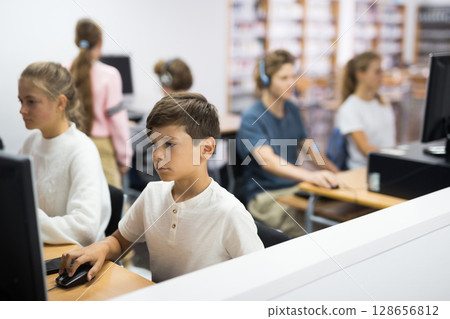 Portrait of a ten-year-old schoolboy at a computer 128656812