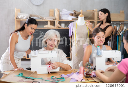 Group of women sew and work with mannequin at master class 128657001
