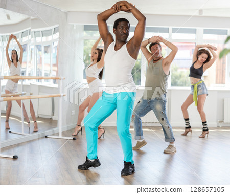Expressive African American mastering modern vogue dance in studio Expressive African American mastering modern vogue dance in studio 128657105