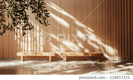 Sunlit wooden benches casting shadows in serene interior 128657235