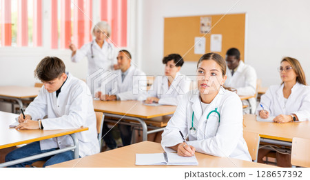 Young girl medical intern listening to lecture at university 128657392