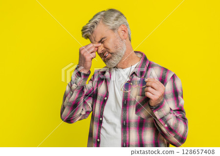 Mature man removing glasses, tired eyes discomfort, post-work fatigue sign, subtle strain expression Mature man removing glasses, tired eyes discomfort, post-work fatigue sign, subtle strain expression 128657408