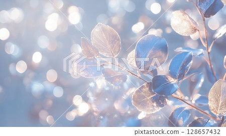 Elegant metallic leaves with bokeh effect in soft blue 128657432
