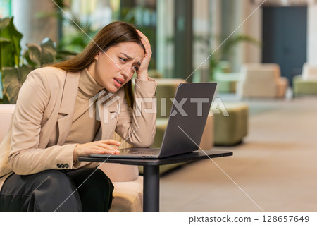 Caucasian businesswoman girl using laptop surprised by bad news, fortune loss, fail, lottery results Caucasian businesswoman girl using laptop surprised by bad news, fortune loss, fail, lottery results 128657649
