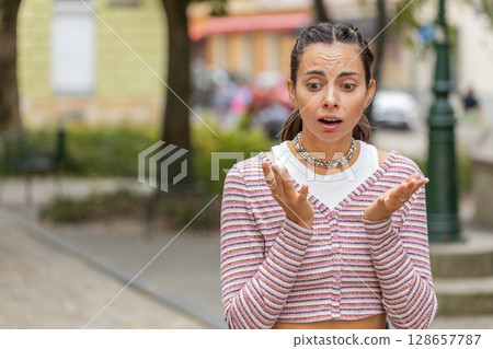 Sad unhappy frustrated woman girl walking alone in city street, feeling bad, annoyed, grief, problem 128657787