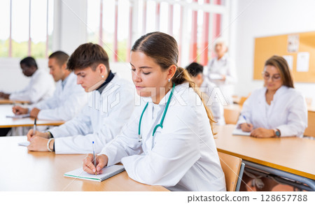 Young woman medical student attending lecture in university 128657788