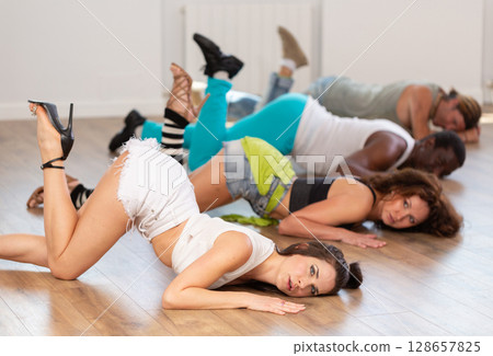 Female dancer performing contemporary sass dance floorwork in studio 128657825