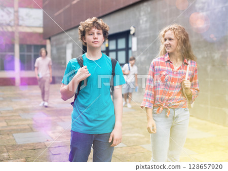 Teens coming home after school classes 128657920