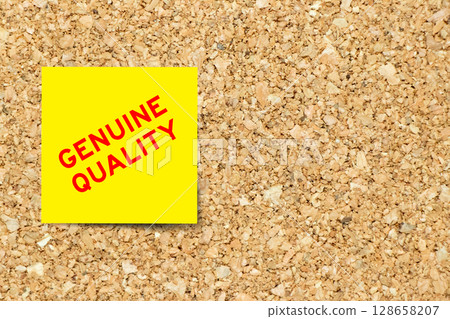 Yellow note paper with word genuine quality on cork board background with copy space Yellow note paper with word genuine quality on cork board background with copy space 128658207