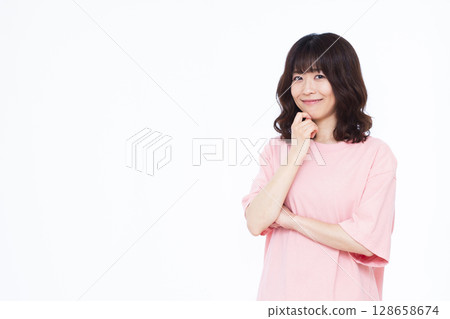 Woman thinking with a smile Woman thinking with a smile 128658674