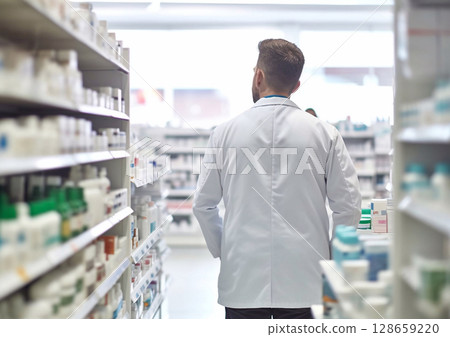 Male pharmacist consultant at pharmacy walking between shelves.Macro.AI Generative Male pharmacist consultant at pharmacy walking between shelves.Macro.AI Generative 128659220