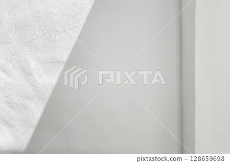 White Concrete Wall with Light, Shadow, and Pole. White Concrete Wall with Light, Shadow, and Pole. 128659698