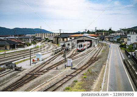 Townscape with a local railway and depot (blue summer sky) 128659900