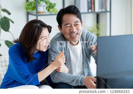 Middle-aged woman watching TV 128660281