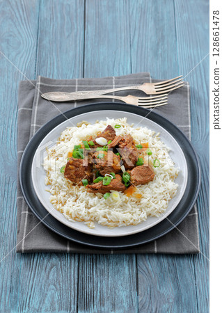 beef slow cooked with gravy served over rice beef slow cooked with gravy served over rice 128661478