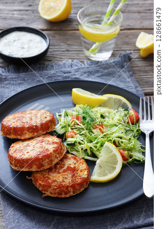 Hot Smoked salmon burgers, patties and coleslaw 128661479